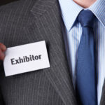 Businessman,Attaching,Exhibitor,Badge,To,Jacket